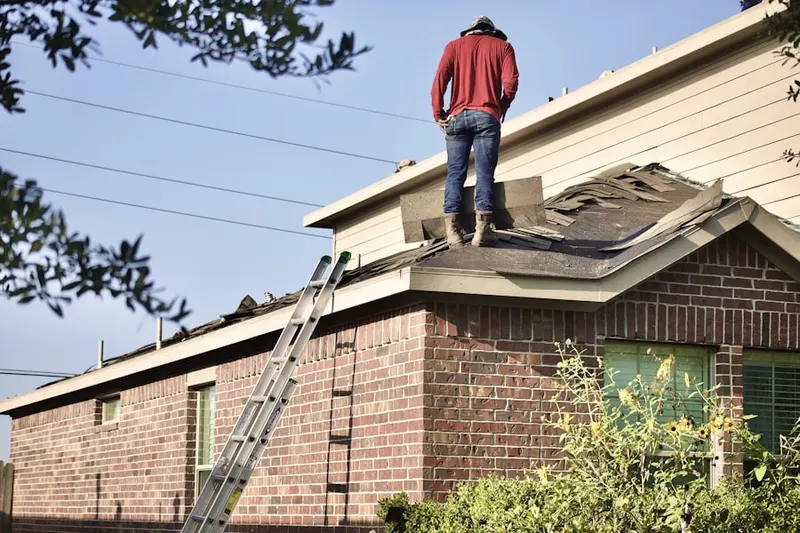 Professional roofer working on a residential roof in Ponderosa Forest
